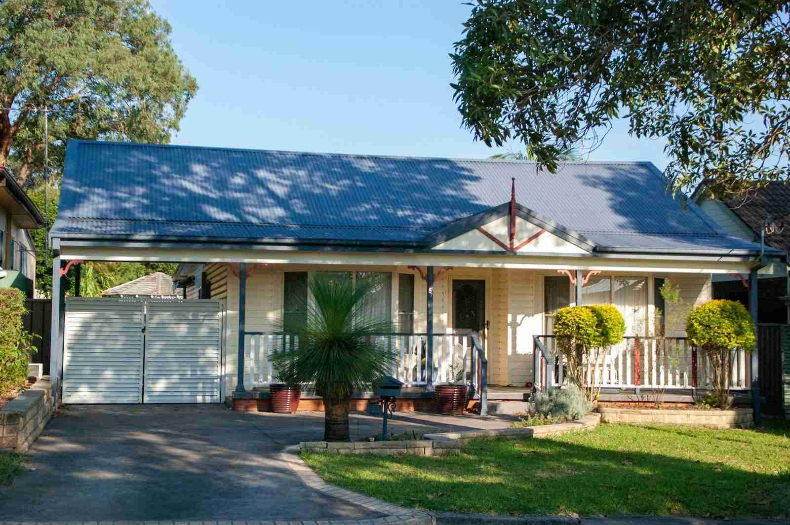 House clearing Energy clearing a small white house with a blue roof