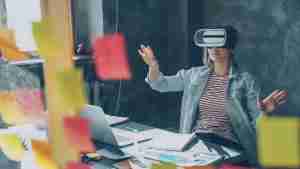 Woman explores virtual reality with hands outstretched.